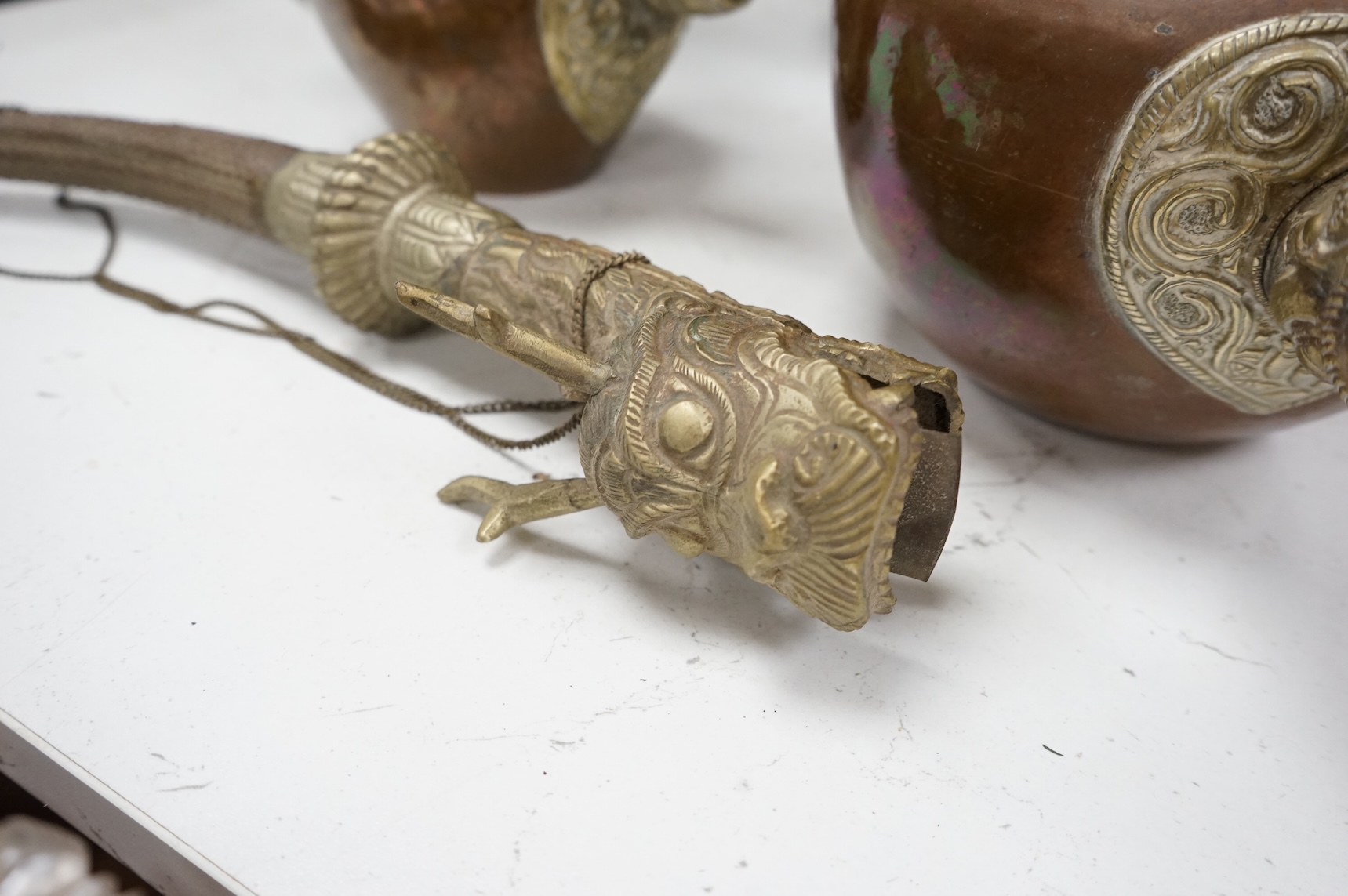 A collection of Asian embossed metalware, largest 41cm high